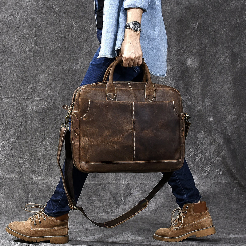 Vintage brown leather shoulder bag with two side handles and crossbody strap