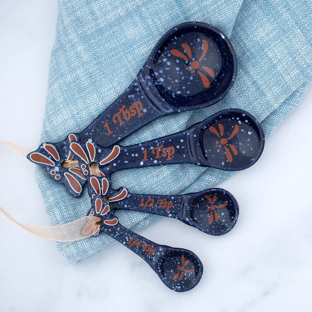 Dark speckled ceramic measuring spoons with dragonfly art and 1 tsp, 1/2 tsp markings