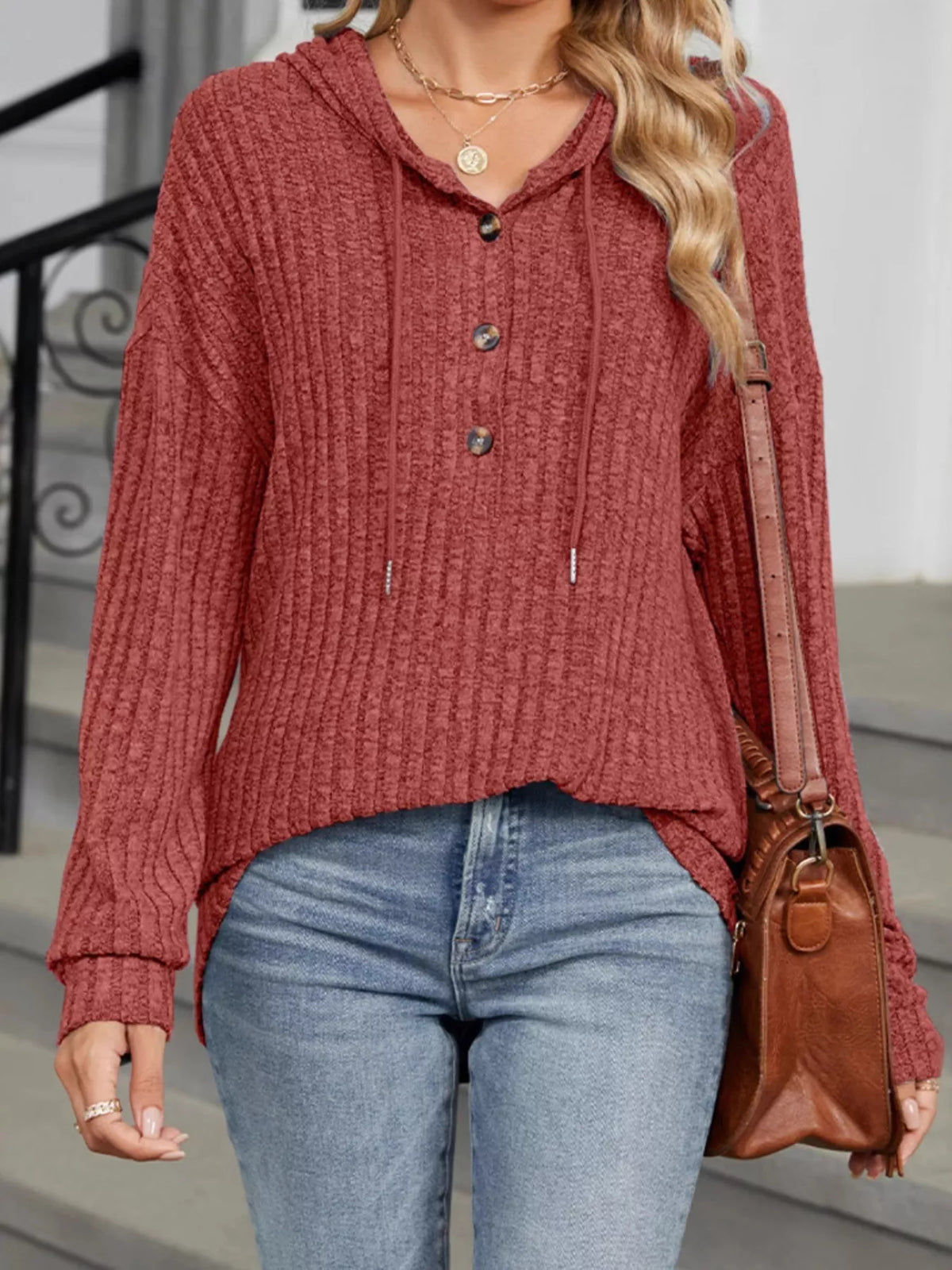 Ribbed knit hoodie with hood, drawstring, and button front in rust red.