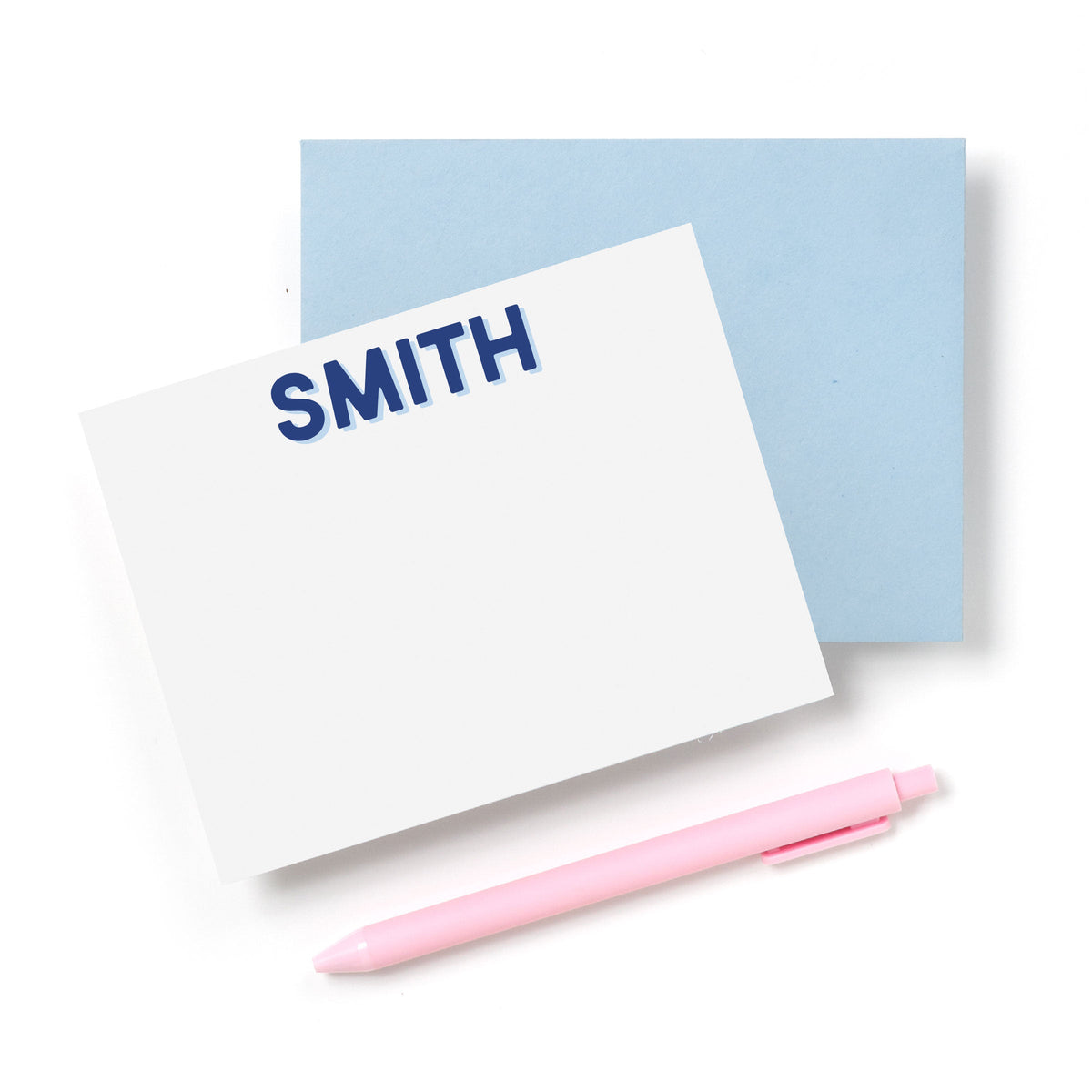 Personalized stationery cards with blue name stamp reading SMITH, plus pink pen