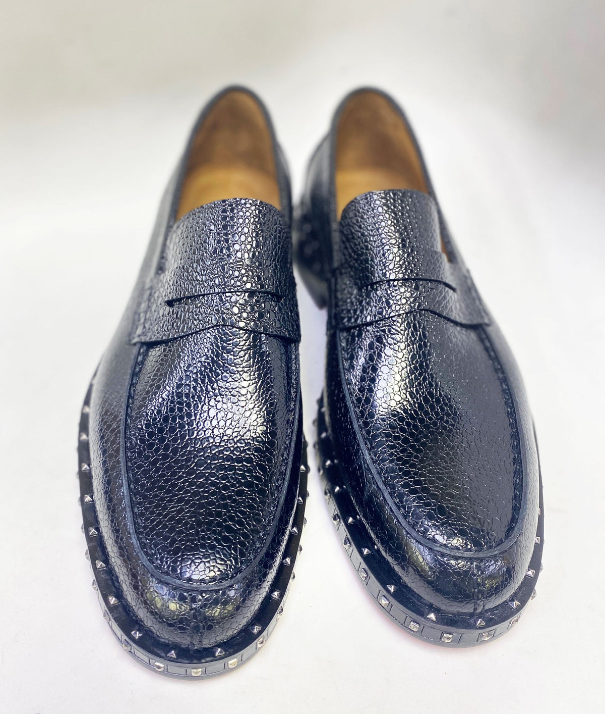 Pair of caviar leather loafers with slip-on vamp and studded platform soles