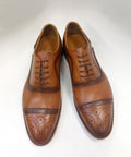 Cognac calfskin oxford shoes with brogue detailing and lace-up front