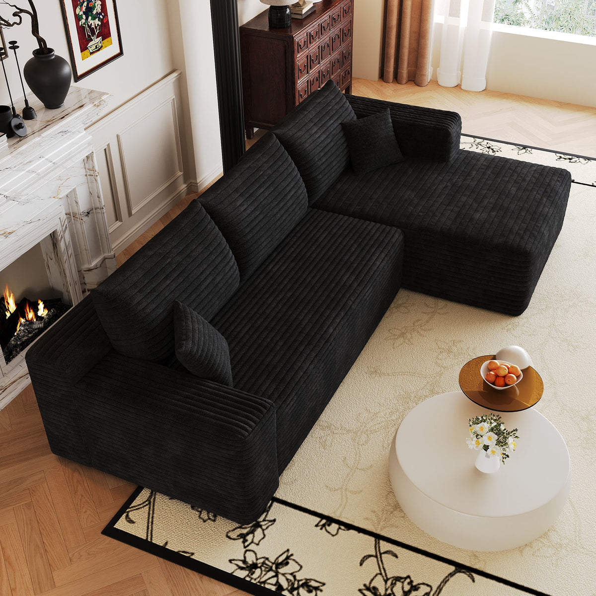Corner view of dark plush corduroy sectional sofa with chaise and armrest