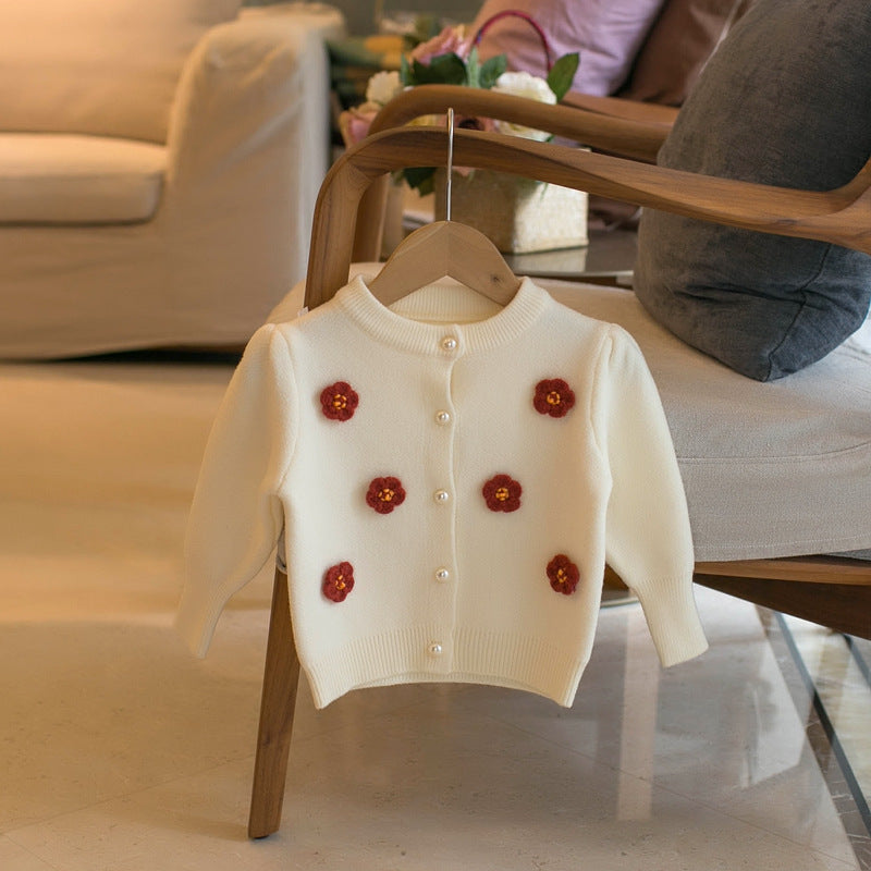 Cream children's cardigan sweater with flower appliques and button front