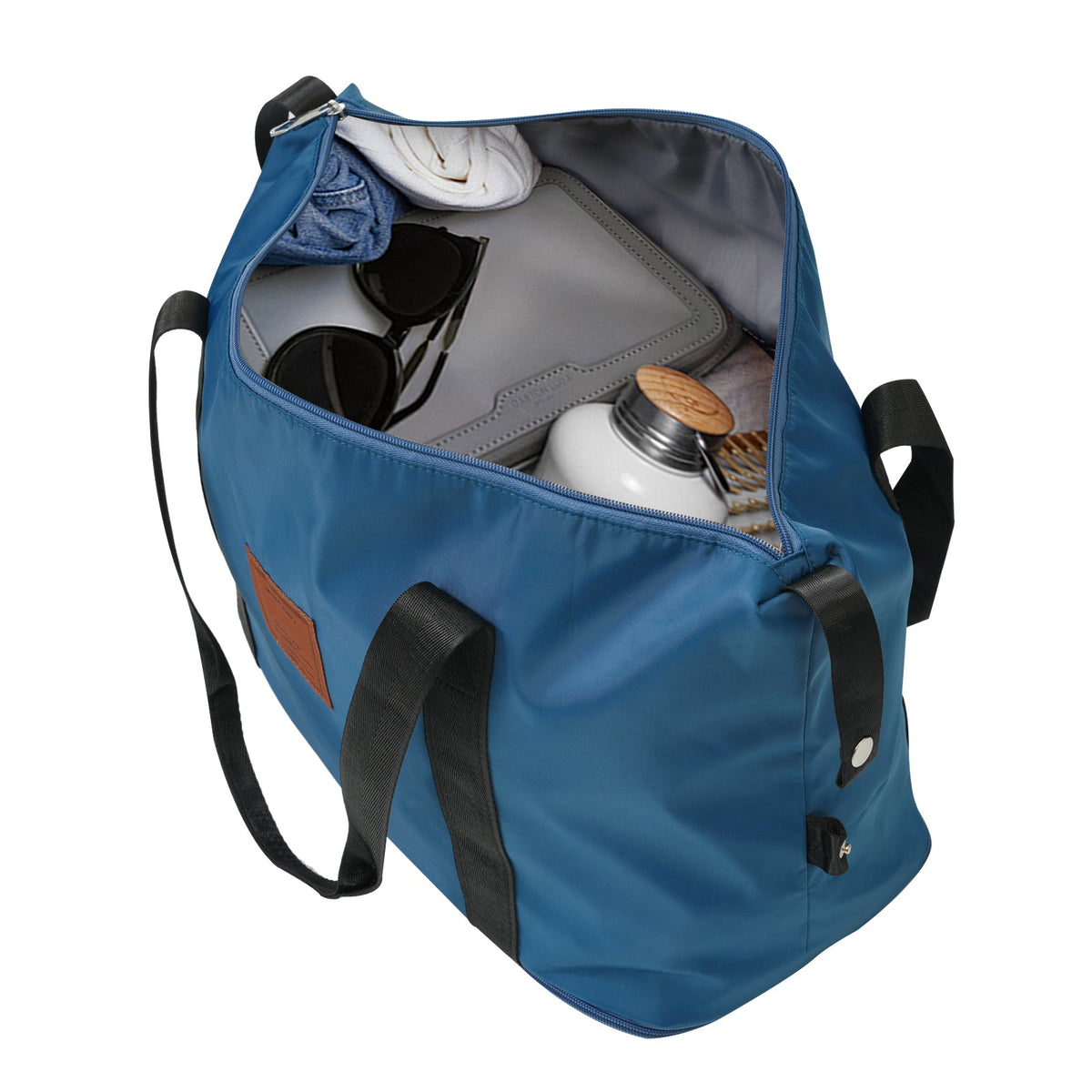 Blue expandable duffel bag open with interior pockets and straps, showing stored items
