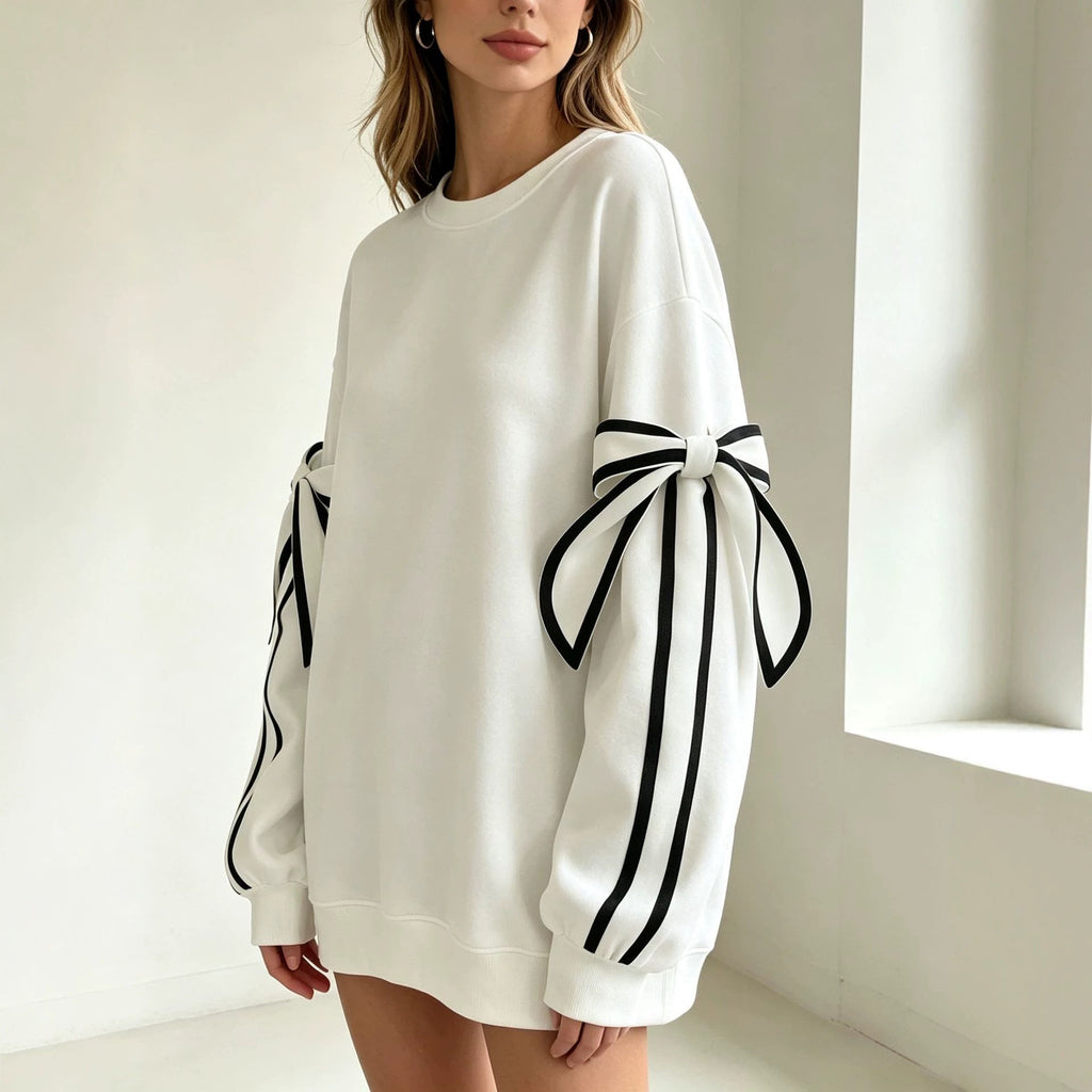 White crewneck sweatshirt with striped bow cuff accents and long sleeves.