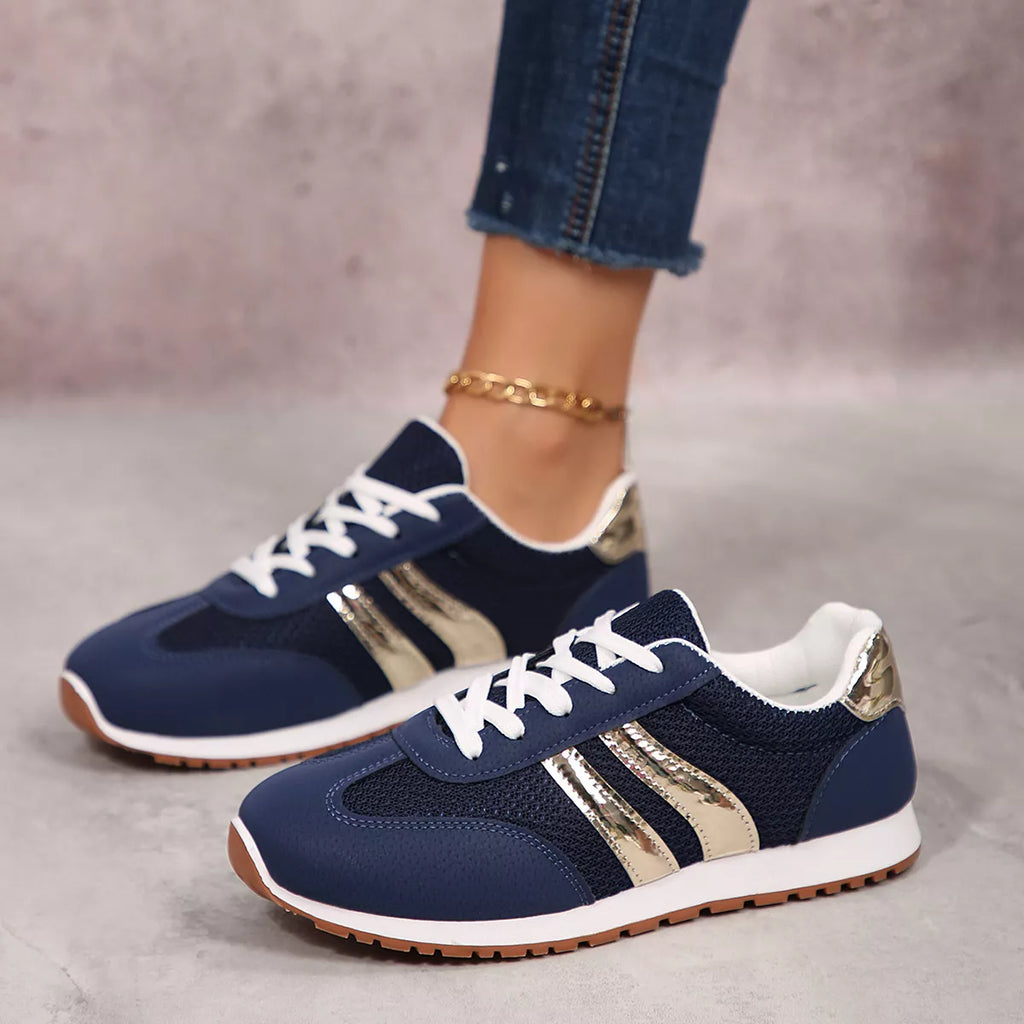 Navy blue lace-up sneakers with gold stripe side panels and white shoelaces