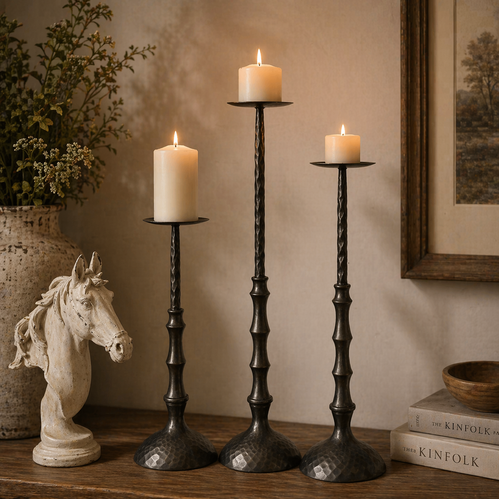 Hammered metal pillar candle holder with textured base, holding white pillar candle