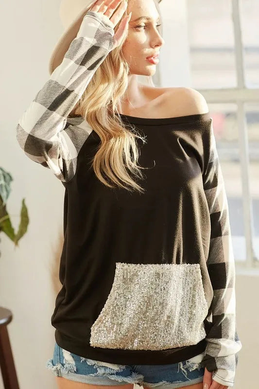 Black French terry top with check raglan sleeves and gold sequin kangaroo pocket