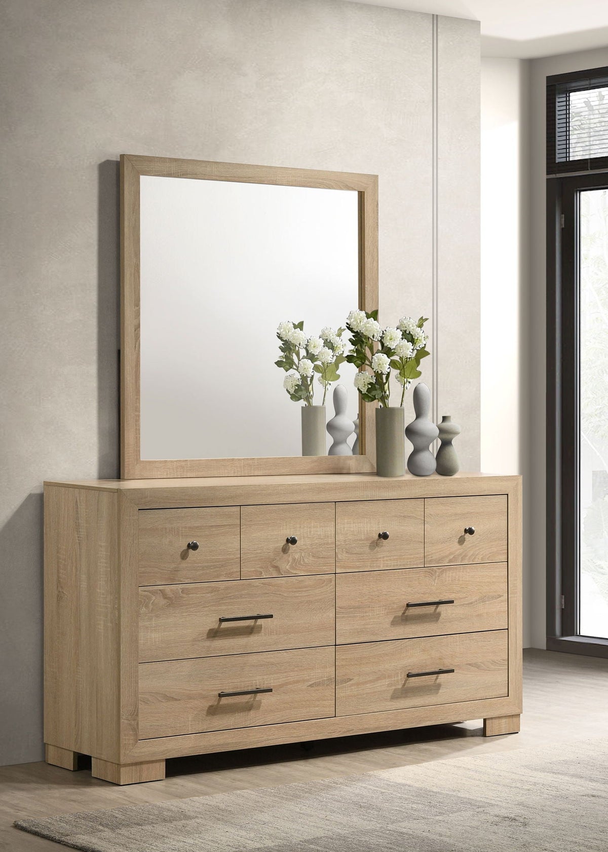 Light oak bedroom dresser with mirror and six drawers; mirror shelf with vases and flowers