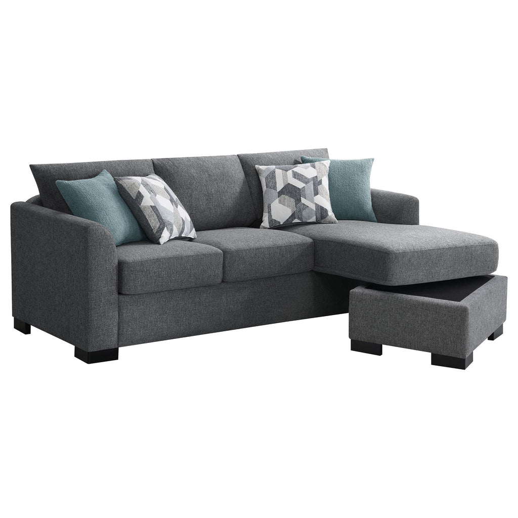 Grey chaise sectional sofa with tufted seat, teal accent pillows, and black base legs