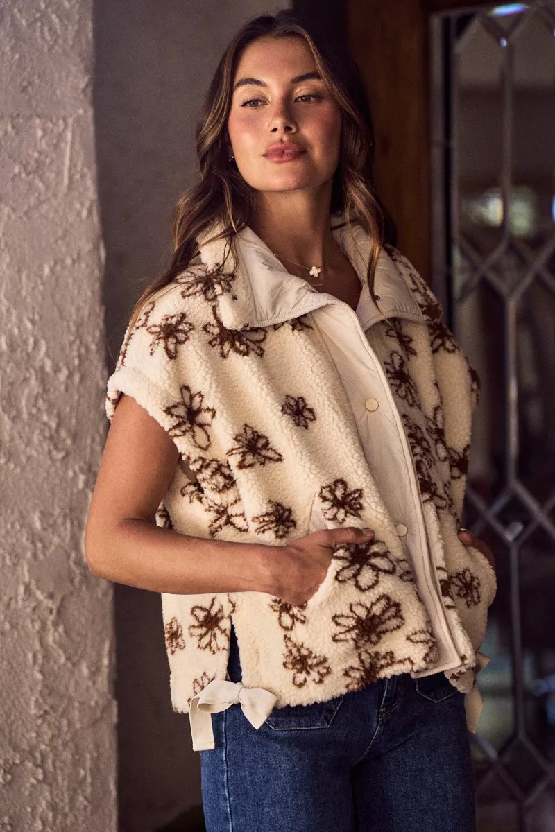 Oversized sleeveless sherpa vest jacket, cream with dark brown floral embroidery, open stand collar