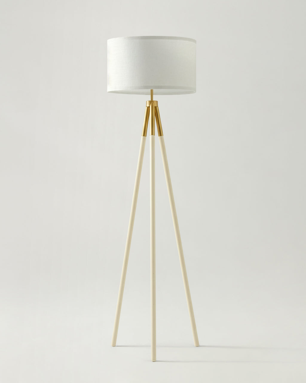 Levi floor lamp with white fabric drum shade and light gold tripod legs