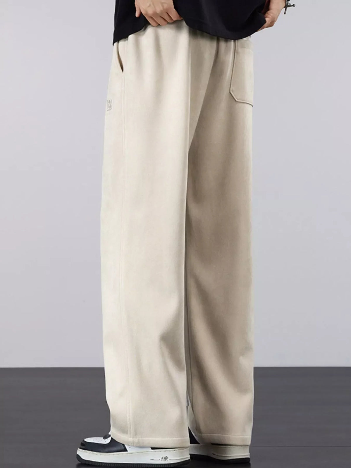 Men's cream drawstring pants with loose fit, wide legs, elastic waistband
