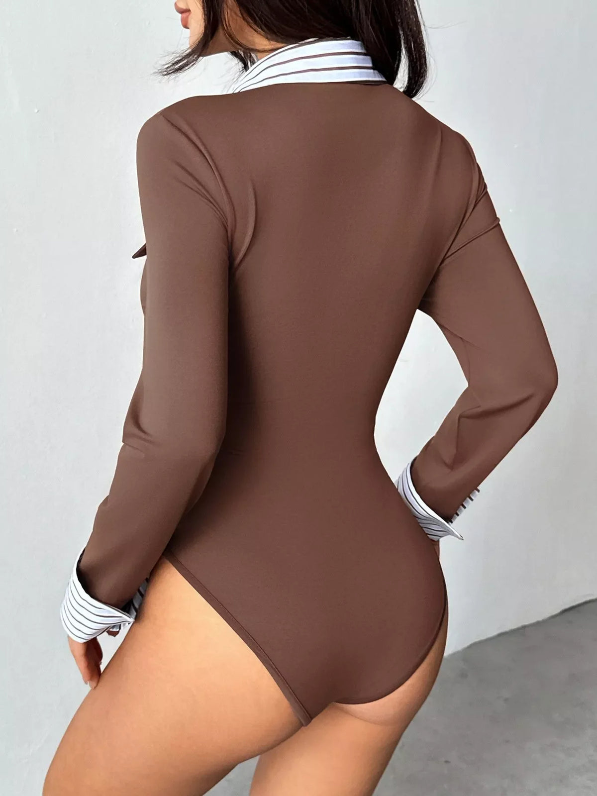 Brown long-sleeve bodysuit with striped cuffs, scoop back, and fitted cut