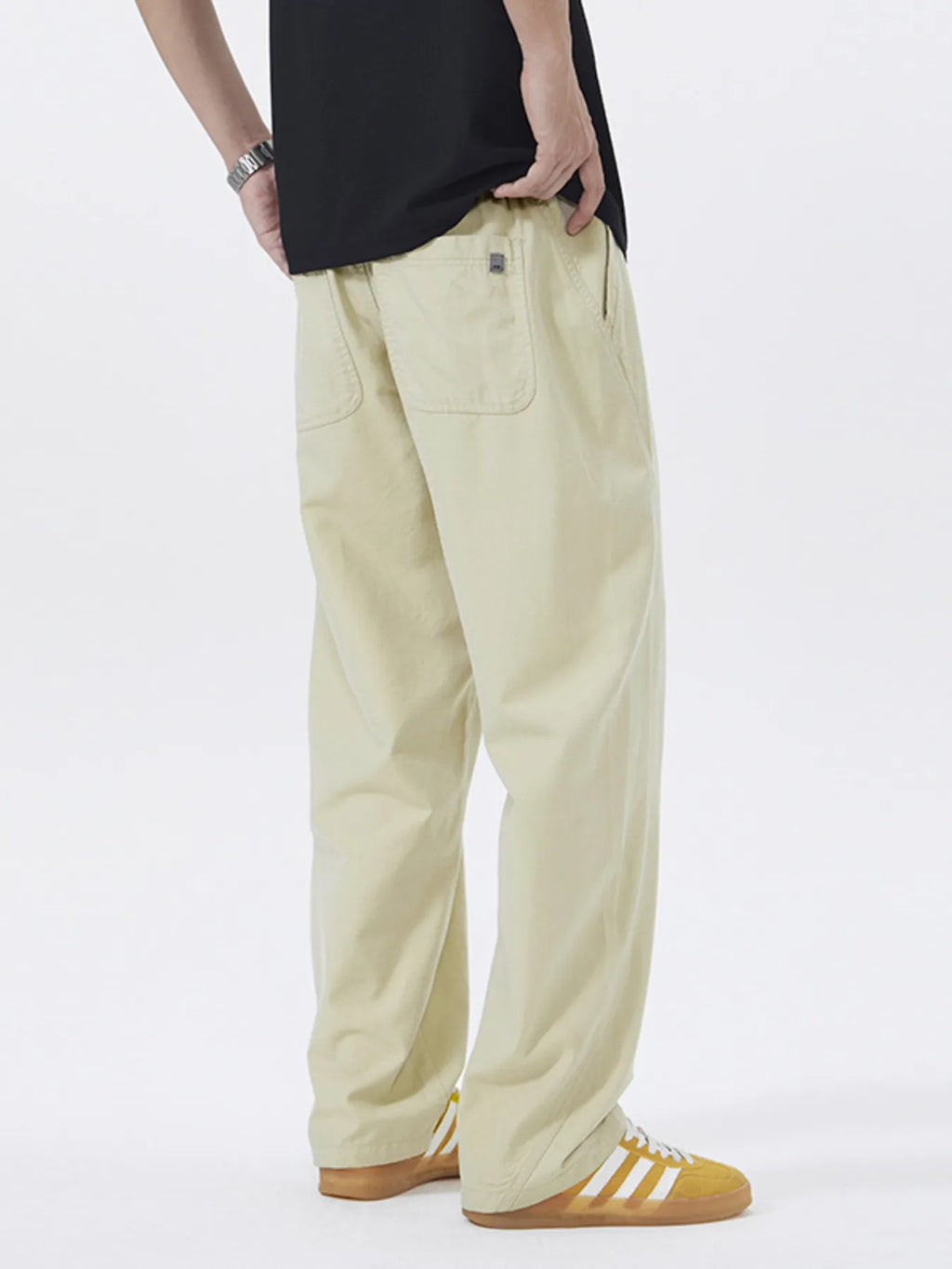 Khaki loose-fit casual pants with visible back pocket and side seam