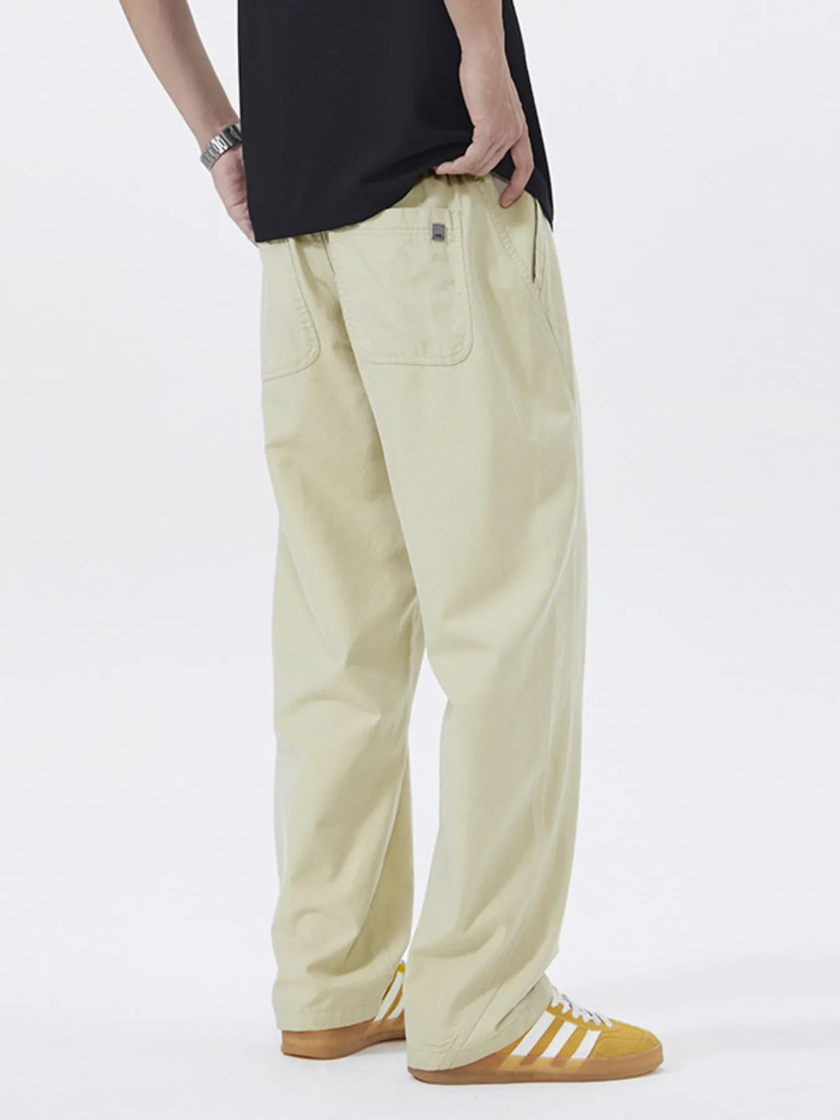 Khaki loose-fit casual pants with visible back pocket and side seam