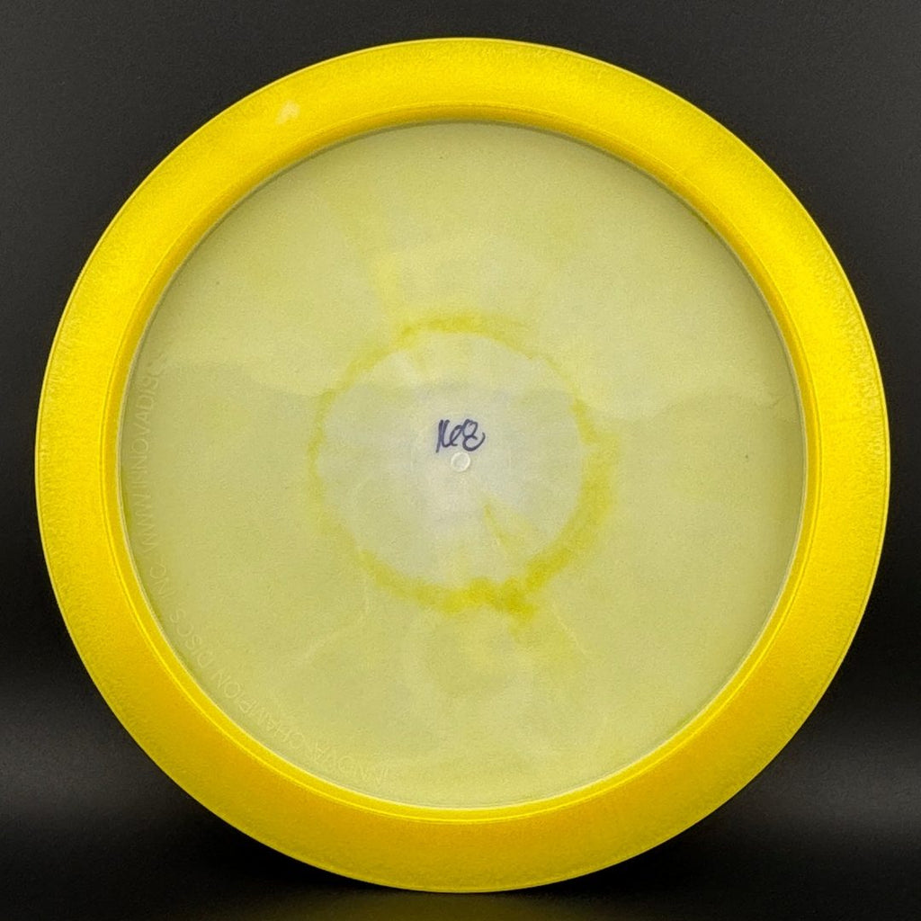 Yellow and clear disc golf disc bottom with molded center stamp