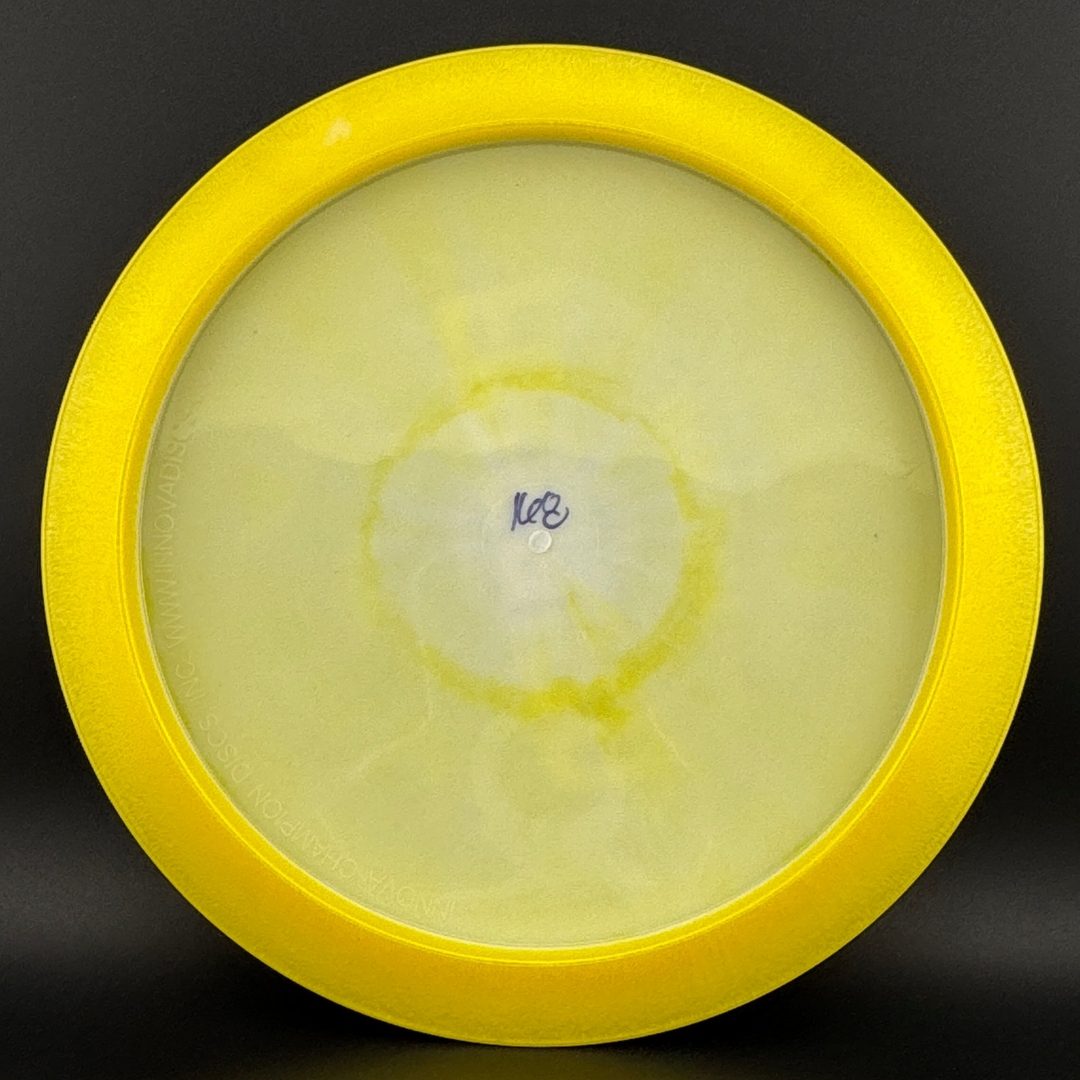 Yellow and clear disc golf disc bottom with molded center stamp