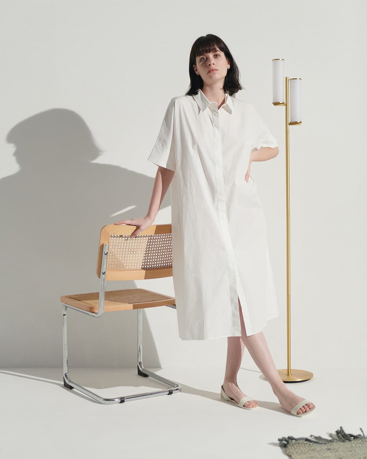 Brass floor lamp with two frosted glass cylinders on a long slim stand