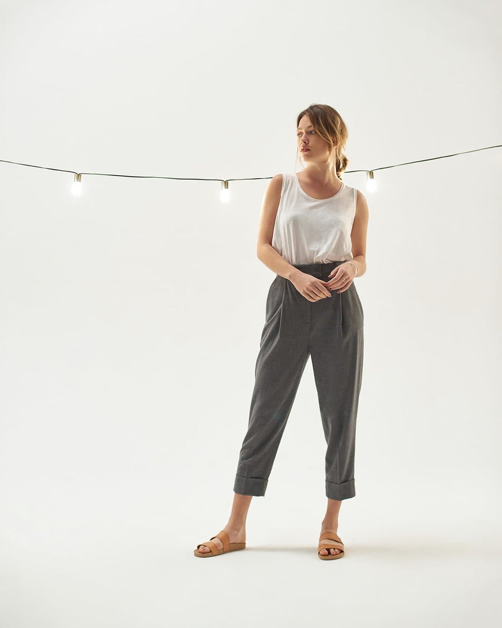 Solar string light strand with clear bulbs and gold caps on black cord