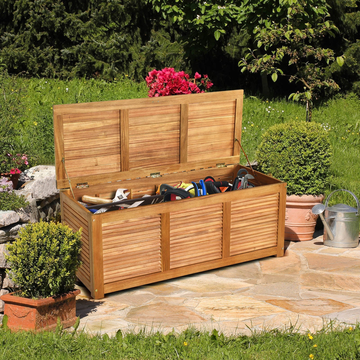 Acacia wood storage bench with hinged top and slatted front panels, outdoors