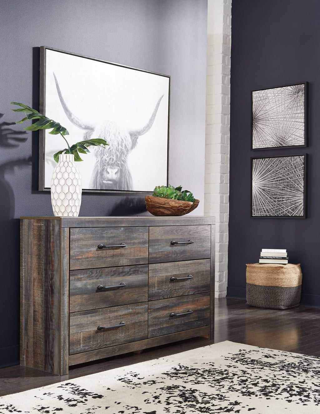 Wood dresser with gray-brown finish and black knobs, paired with wall mirror