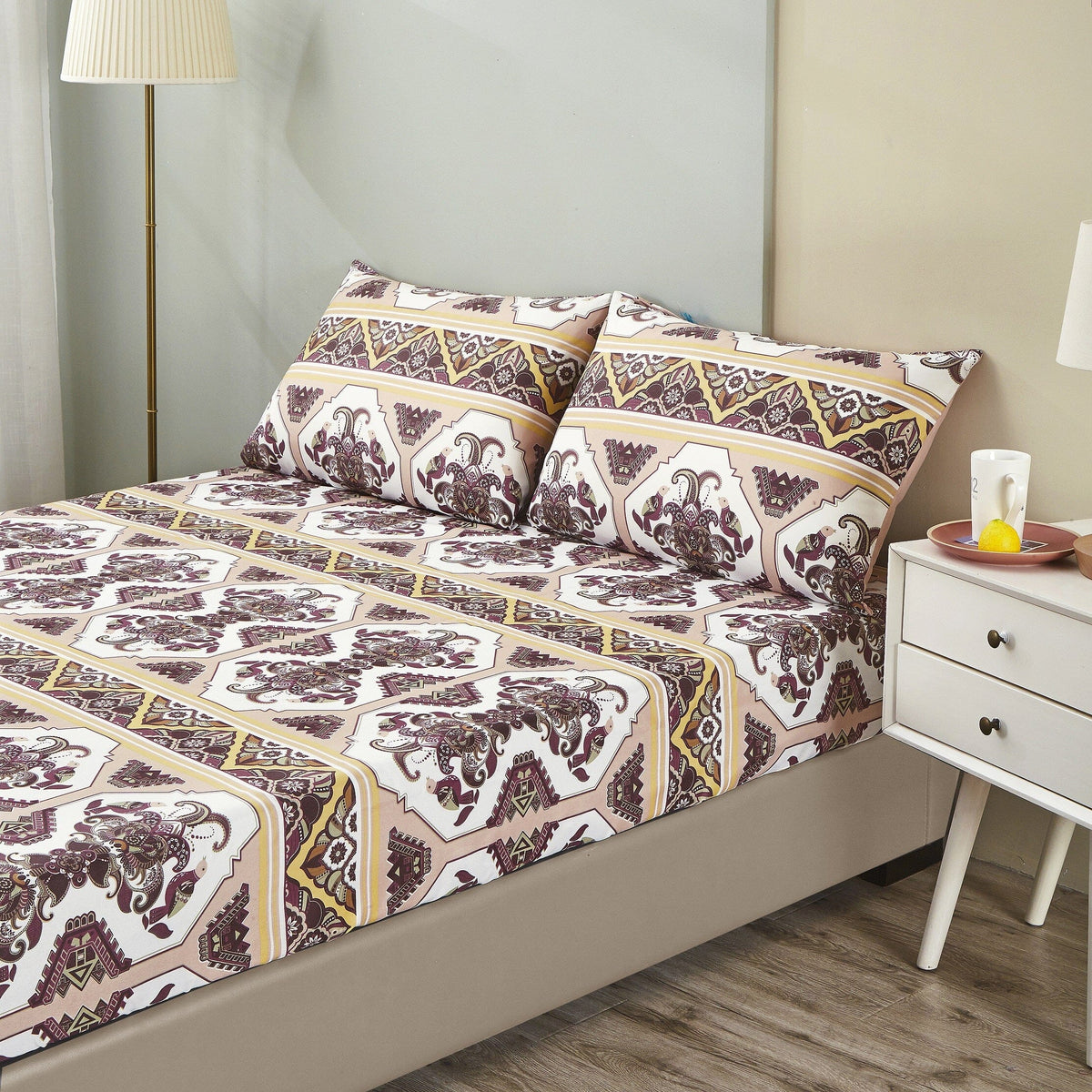 Fitted sheet and pillowcases with repeating ornate medallion pattern, maroon and cream
