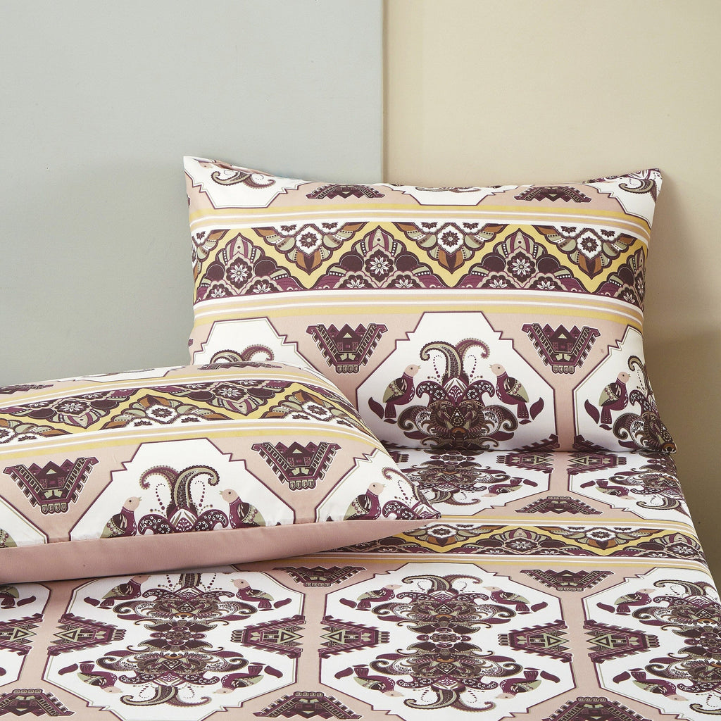 Matching pillowcases and fitted sheet with ornate kilim medallion pattern in burgundy and cream