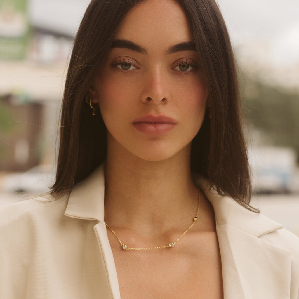 Gold chain necklace with five round diamond-like stones, layered neckline fit