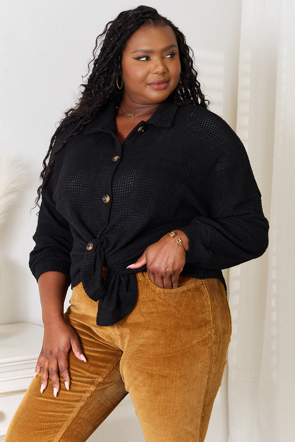 Black waffle-knit collared shirt with button placket and rolled cuff sleeves