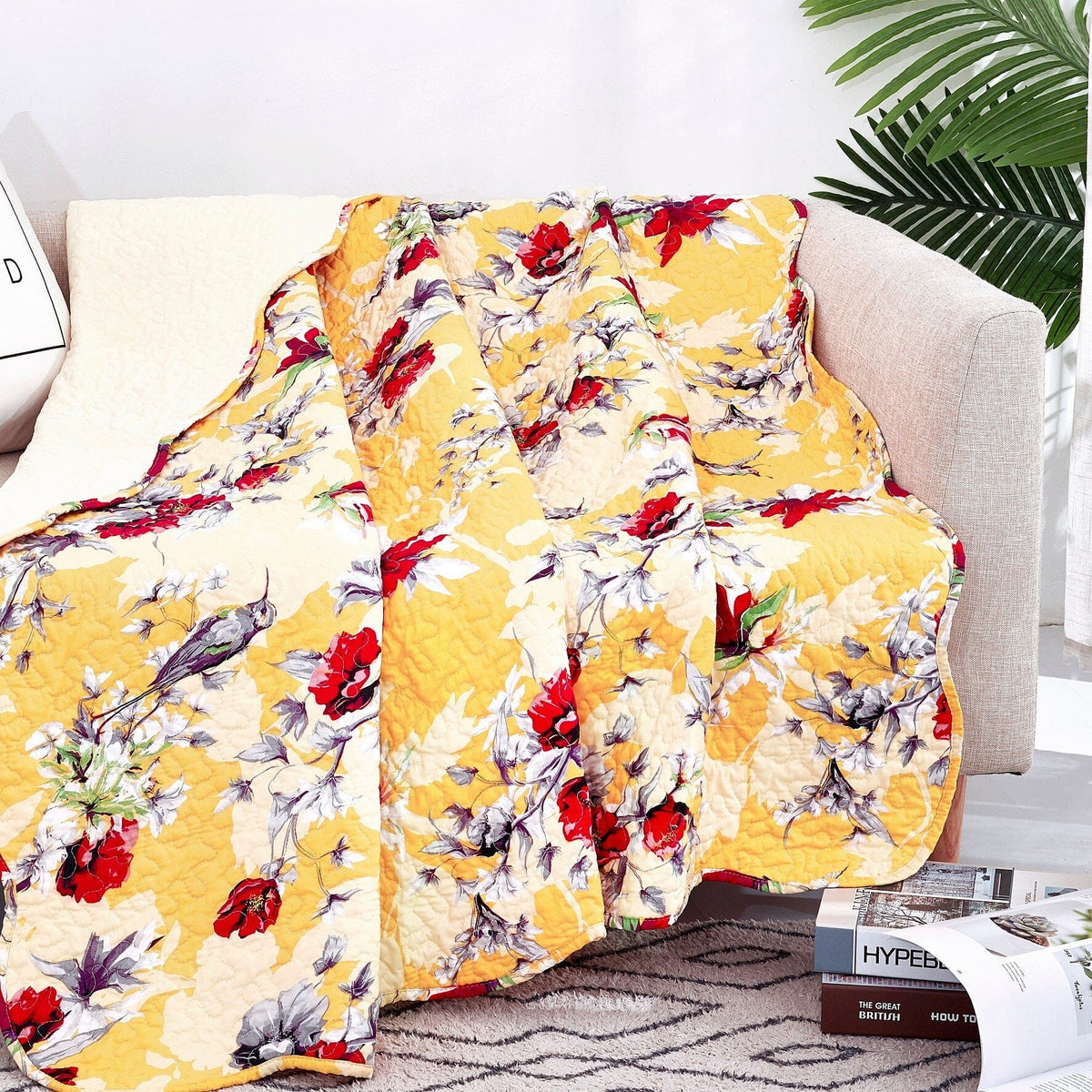 Yellow floral quilted throw blanket with scalloped edges, close view