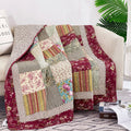 Beige, burgundy patchwork quilted throw blanket with floral and striped fabric blocks.