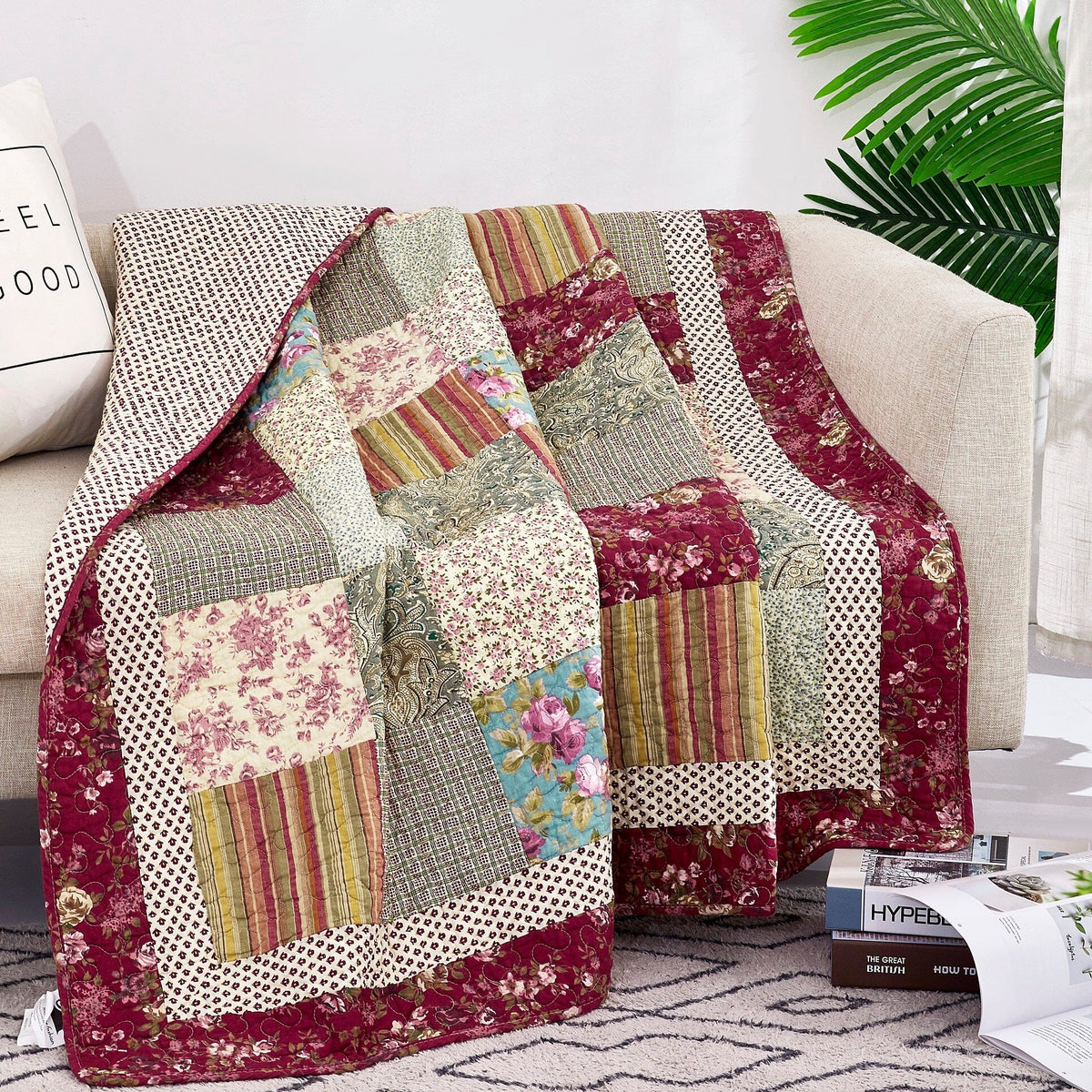 Beige, burgundy patchwork quilted throw blanket with floral and striped fabric blocks.