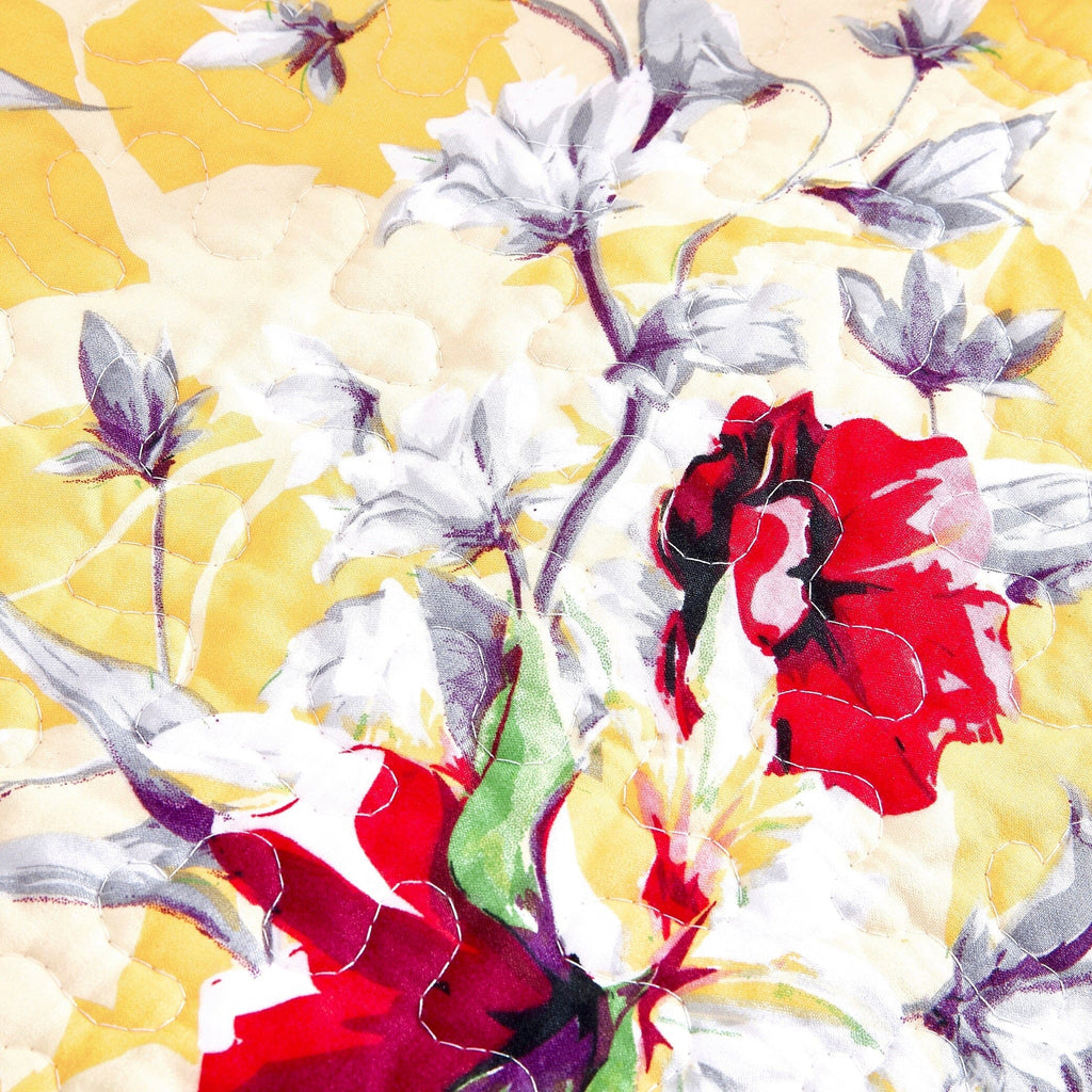 Yellow quilted fabric with large floral and bird motif in red and purple