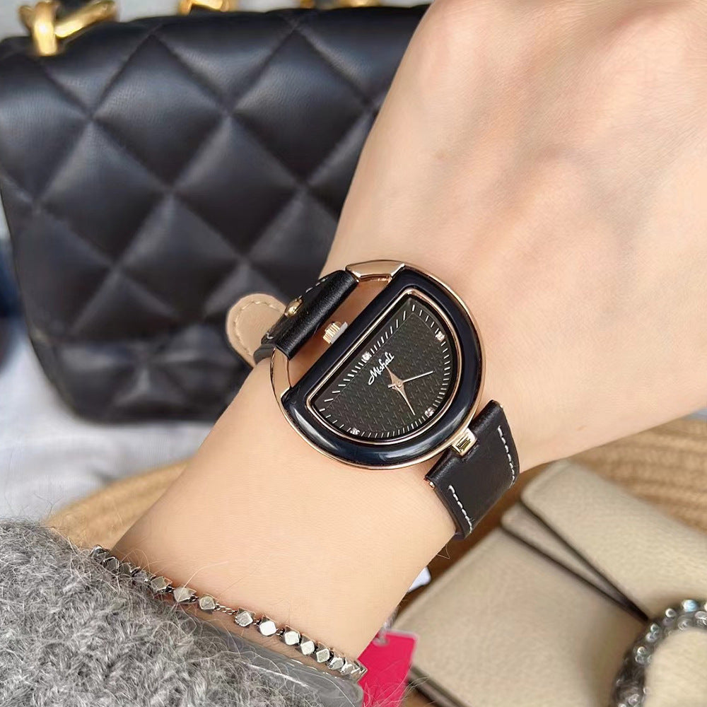 Women’s leather-strap watch with black band and black oval case, black dial.