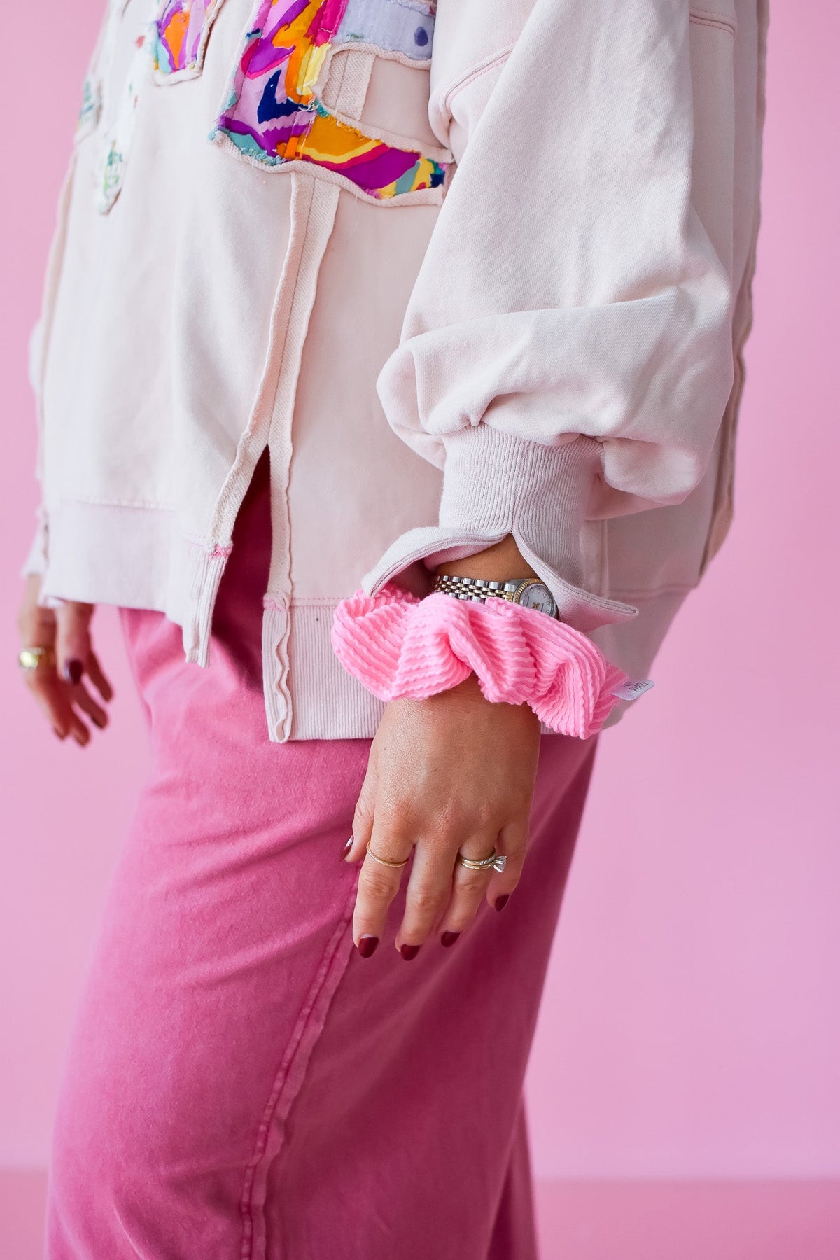 Pink ribbed scrunchy worn on the wrist