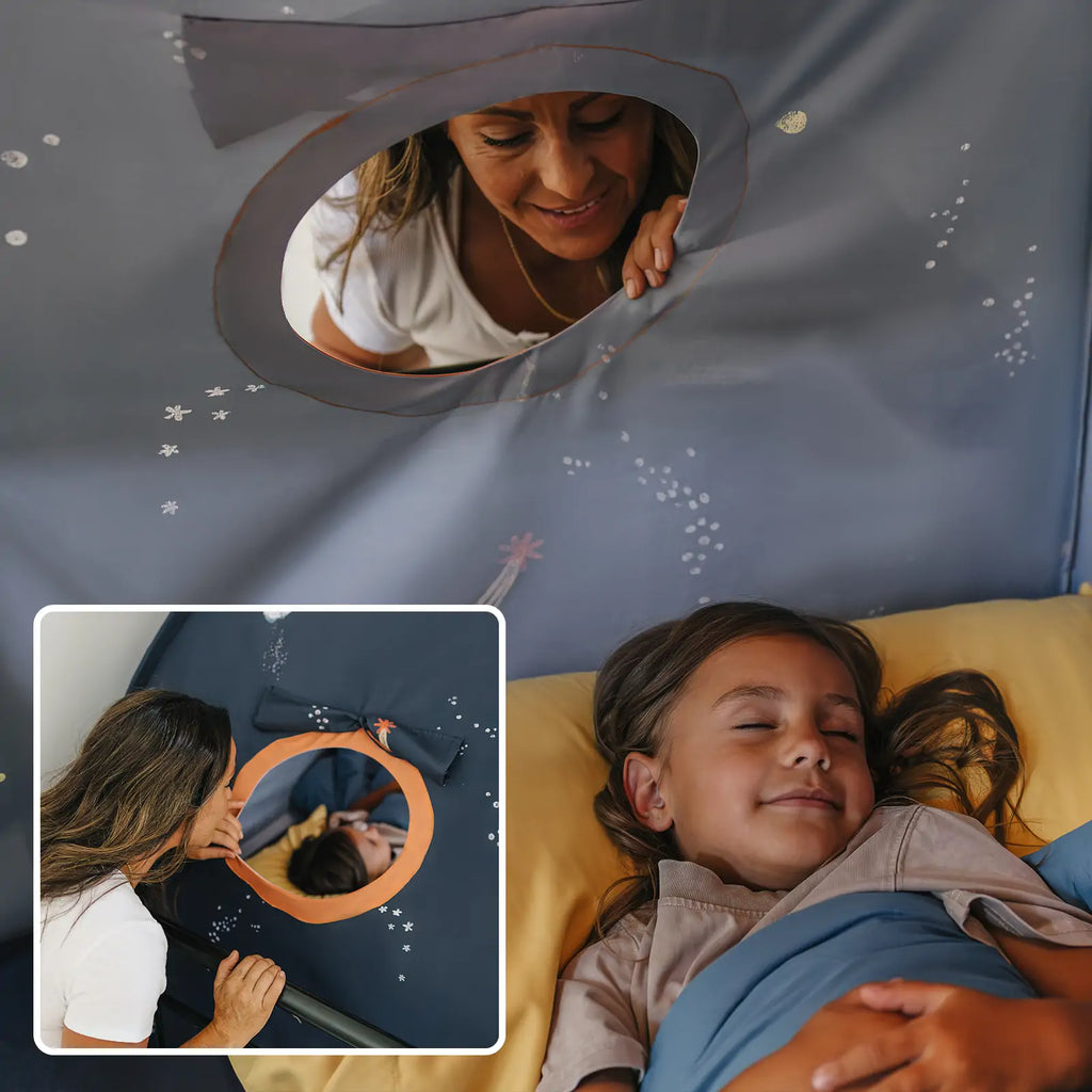 Kids tent with dark navy space print and oval window opening for peek-through