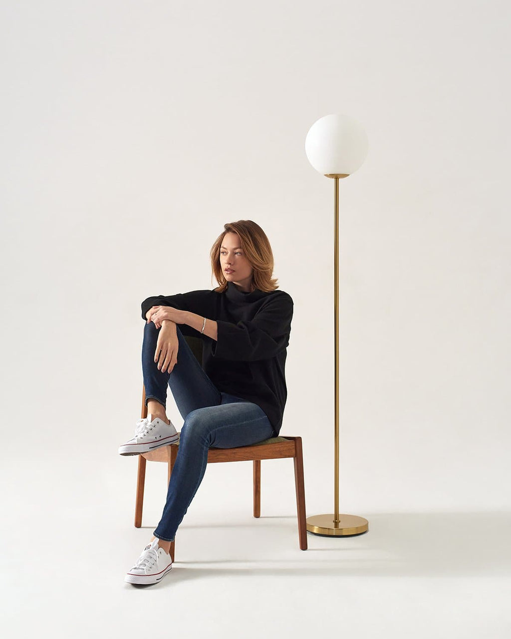 LED floor lamp in antique brass with frosted globe shade and round base