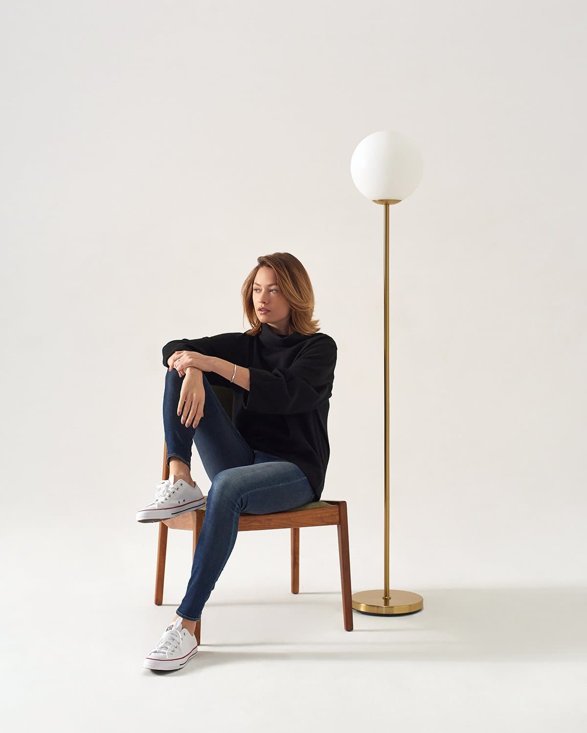 LED floor lamp in antique brass with frosted globe shade and round base