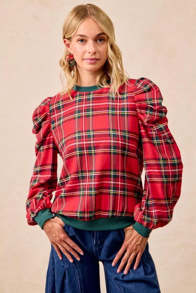 Red plaid top with exaggerated shoulder puff sleeves and green neckline cuffs
