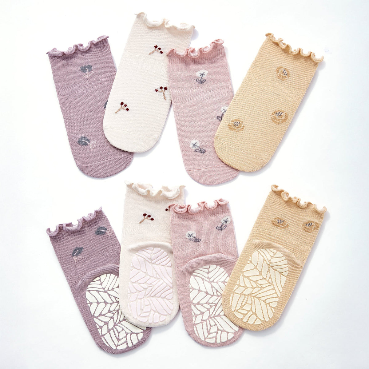 Set of 4 baby non-slip socks in lilac, cream, blush, and yellow with ruffled cuffs