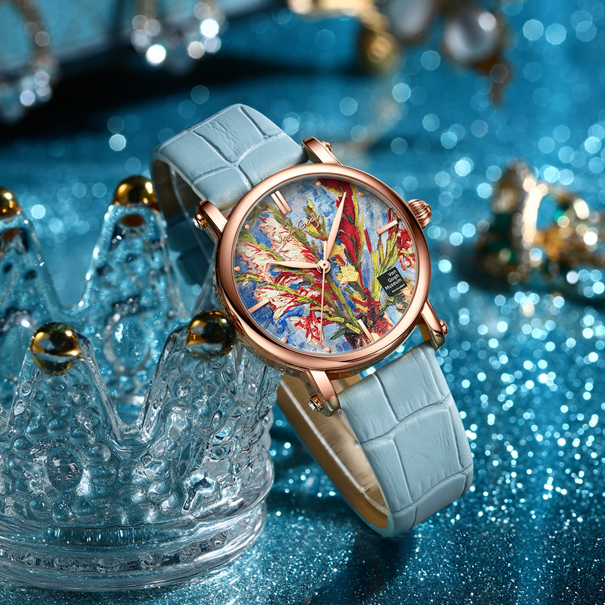 Quartz wristwatch with blue strap and rose-gold case, colorful art dial with gold hands
