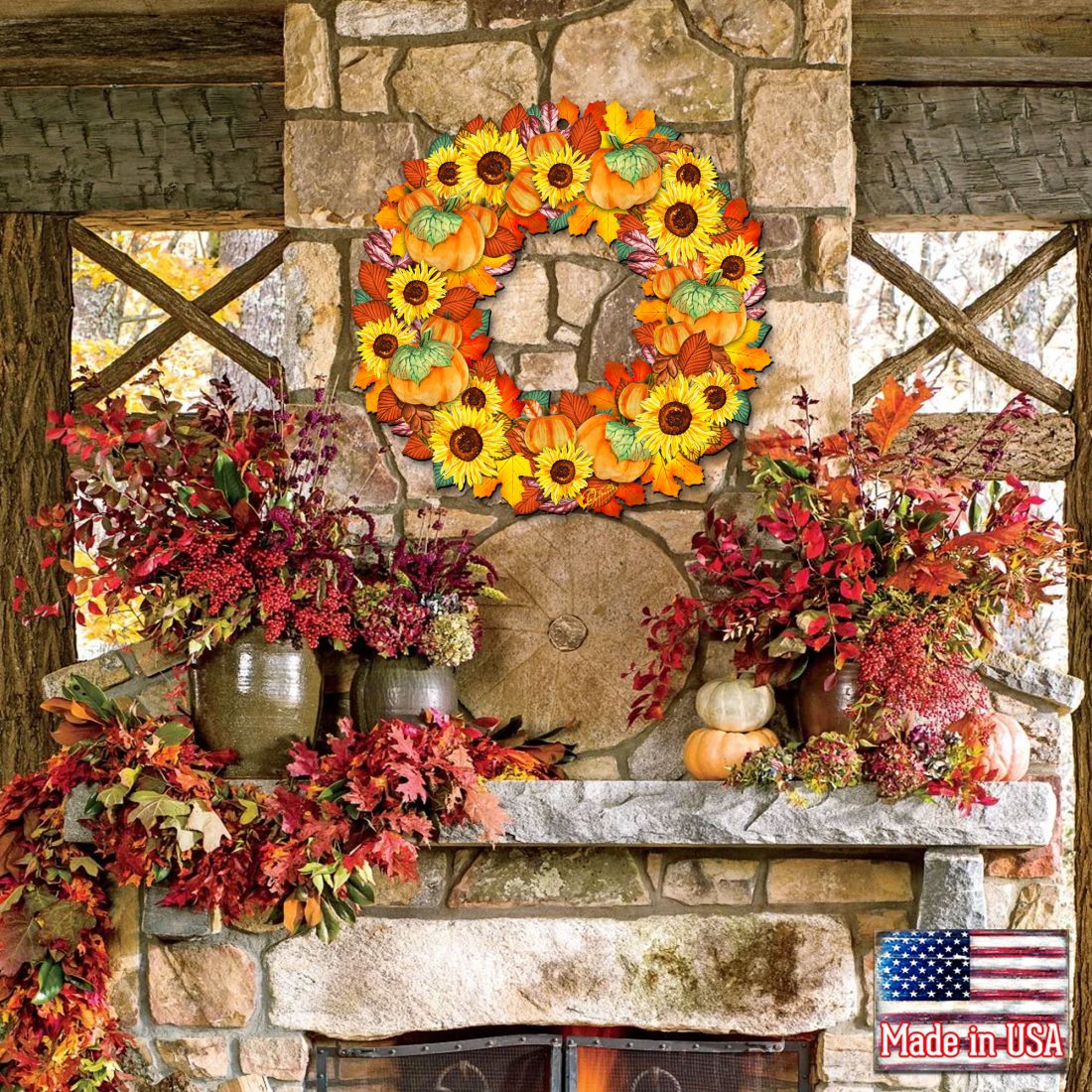 Autumn door wreath with orange pumpkins, green leaves, and sunflower-style blooms