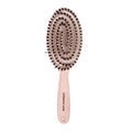 Oval ionic hair brush with dark bristle pins and light pink handle
