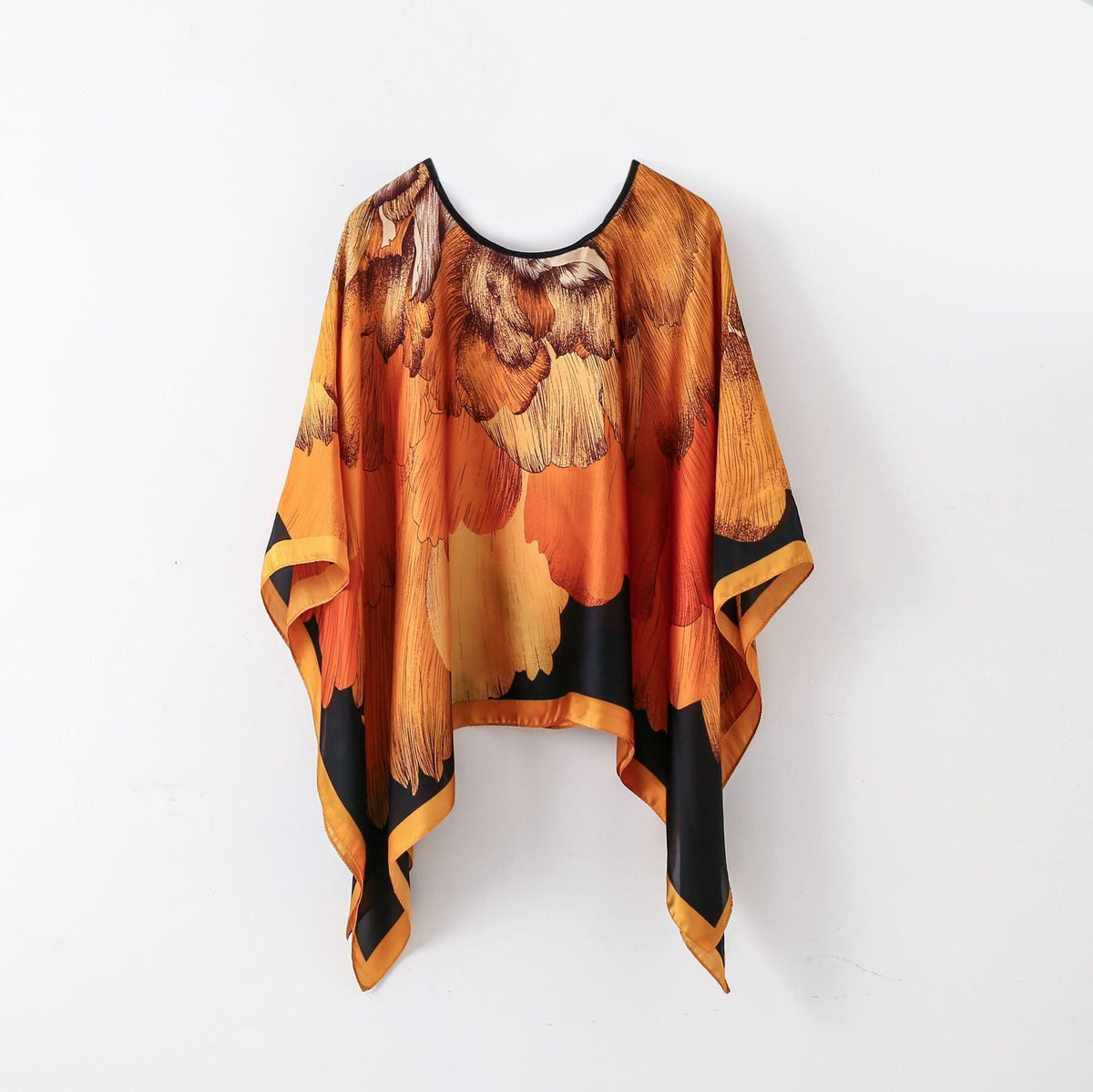 Orange-brown abstract poncho-style pullover shawl scarf with black neckline