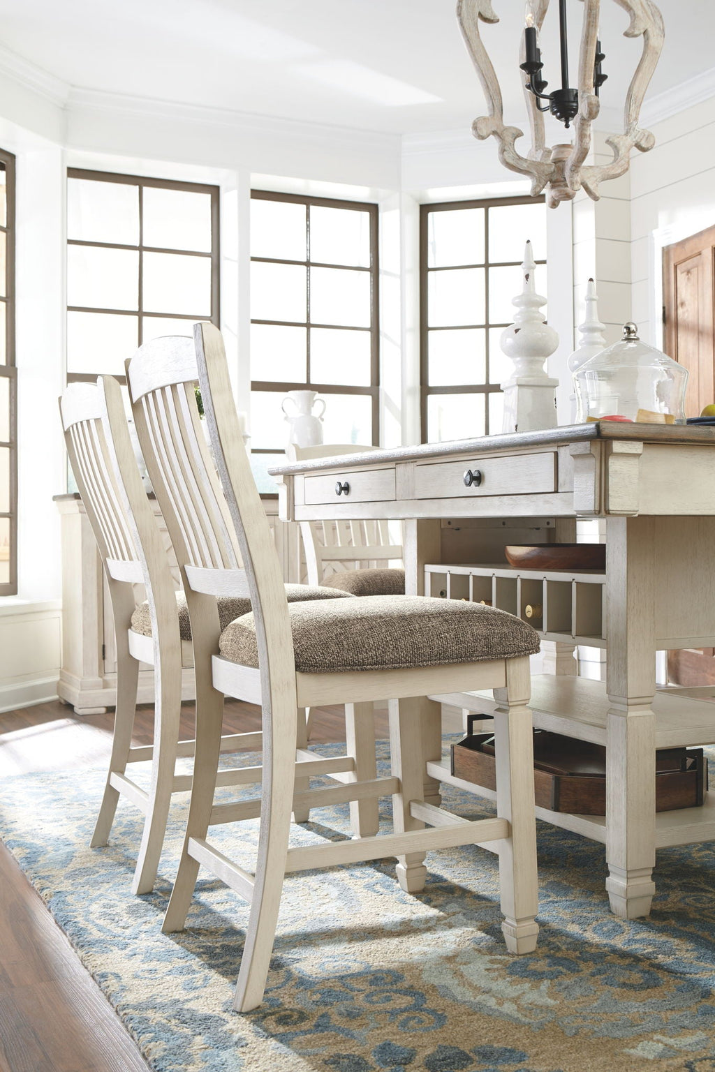 Single cream chair with gray cushion beside beige counter table and lower shelf storage.