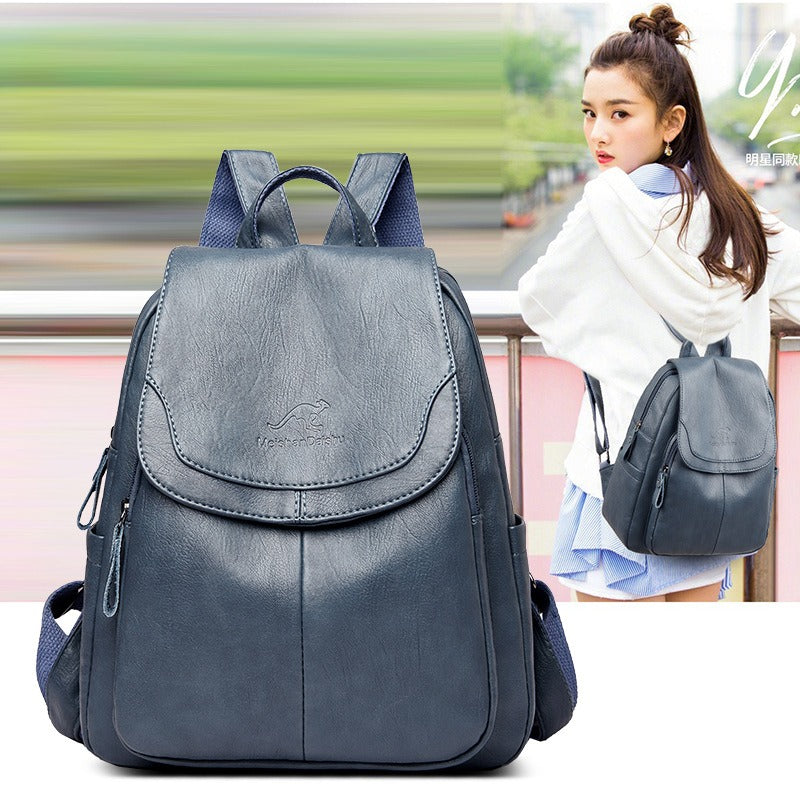 Women’s navy-blue backpack with front flap pocket, top handle, and side zipper details