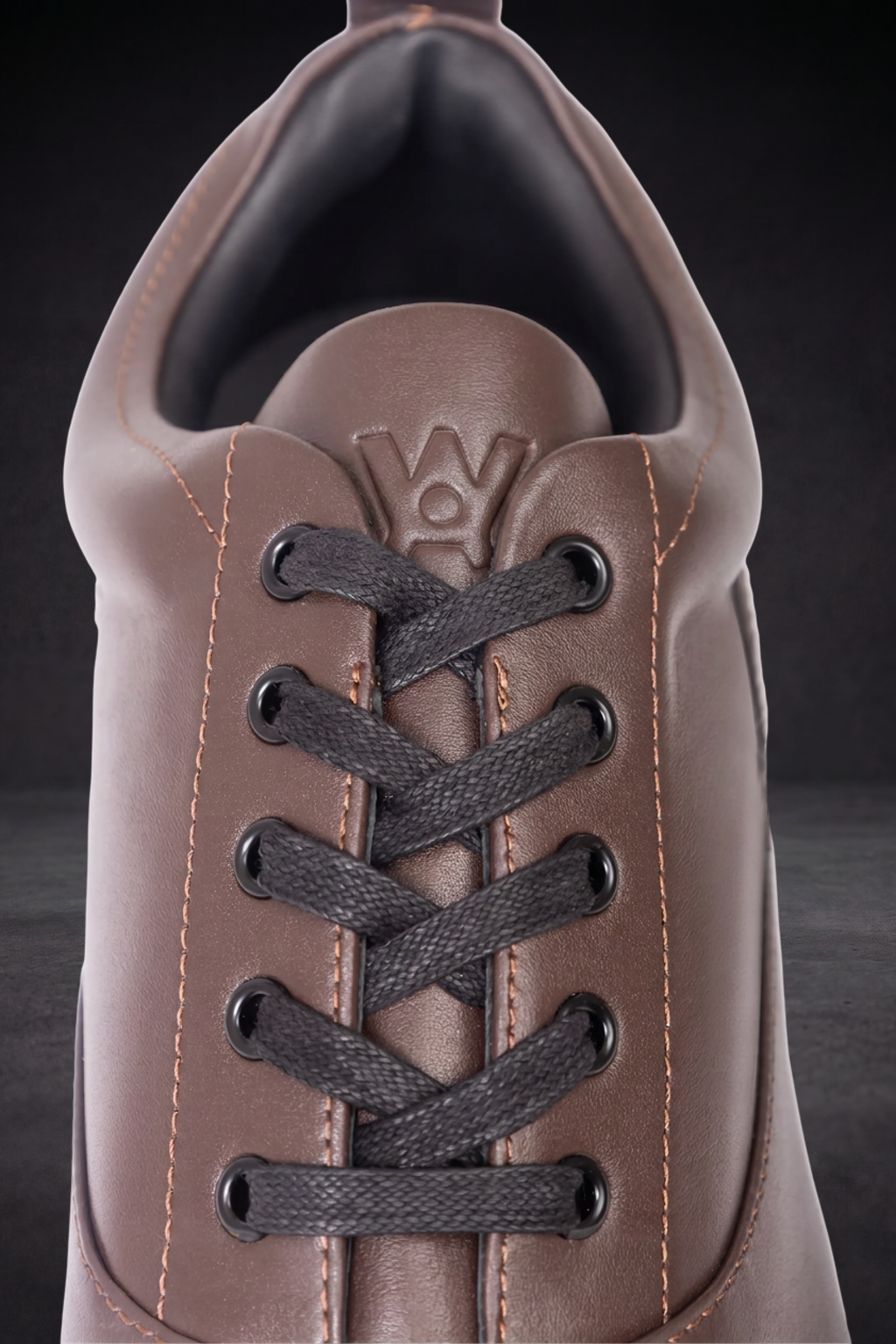Taupe WOA sneaker upper with dark lace-up eyelets and stitched trim