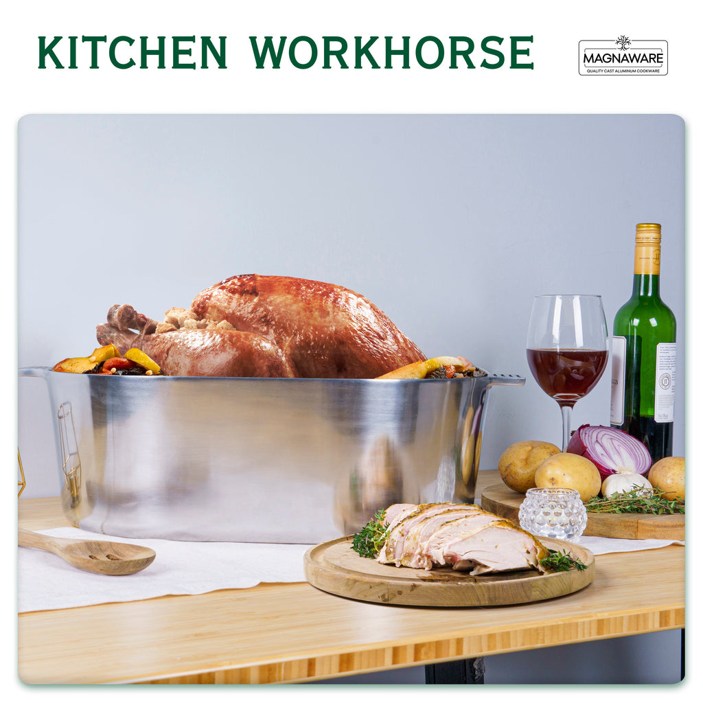 Stainless steel oval dutch oven with domed lid, filled with roasted chicken